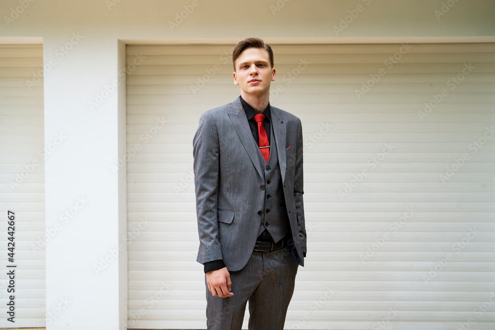 Blonde fashionable teenager in suit posing outdoors Blonde fashionable teenager in suit posing outdoors