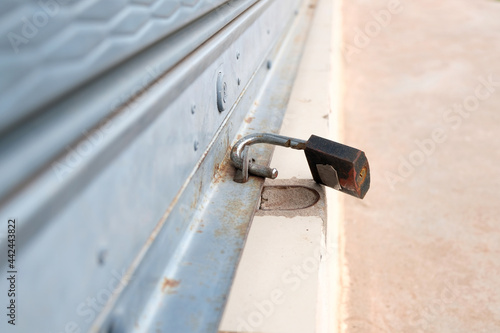 The old padlock that forgot to lock the storefront The concept of property insecurity