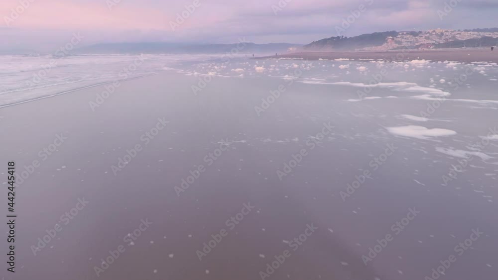 Aerial: Flying over tranquil calm ocean beach at sunset. San Francisco Aerial: Flying over tranquil calm ocean beach at sunset. San Francisco