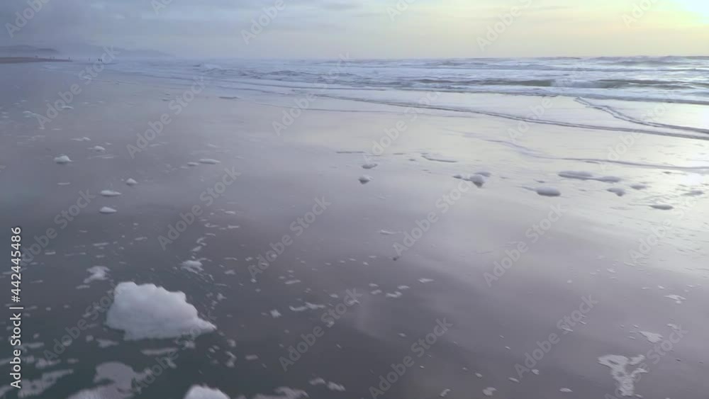 Aerial: Flying over tranquil calm ocean beach at sunset. San Francisco Aerial: Flying over tranquil calm ocean beach at sunset. San Francisco