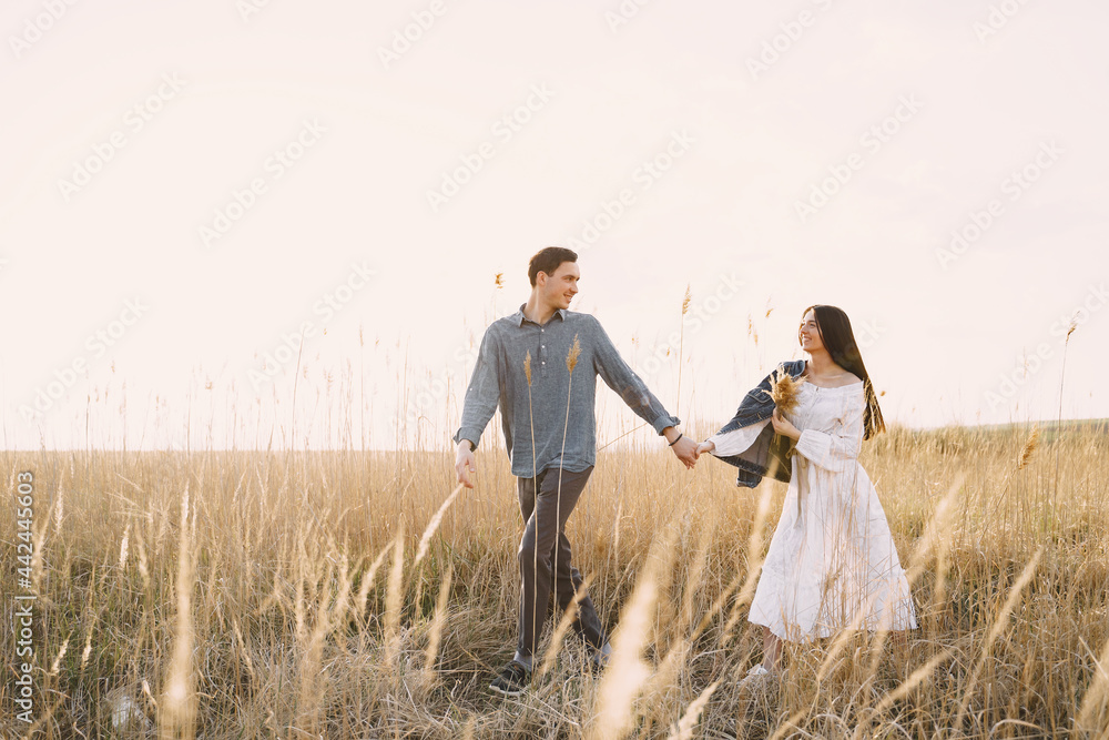 Happy couple in love in wheat field at sunset Happy couple in love in wheat field at sunset