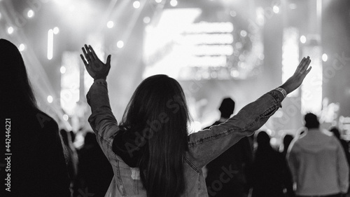 christian concert woman raised hands