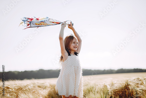 Fototapeta Naklejka Na Ścianę i Meble -  Cute child spend time on a summer field