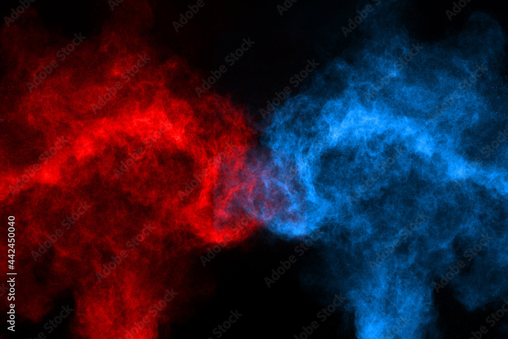 Blue and red color powder explosion on black background. Colored cloud. Colorful dust explode. Paint Holi.