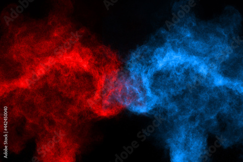 Blue and red color powder explosion on black background. Colored cloud. Colorful dust explode. Paint Holi.