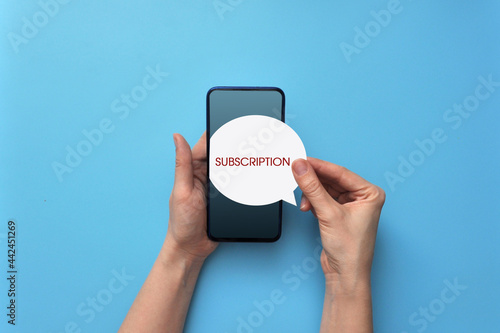 A person with a phone in his hands signed up for a subscription photo