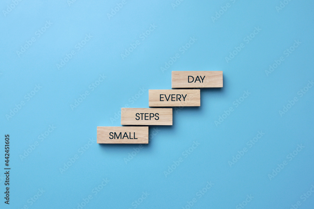 Motivational message: Small steps every day. A symbol of constant movement towards the goal every day Motivational message: Small steps every day. A symbol of constant movement towards the goal every day