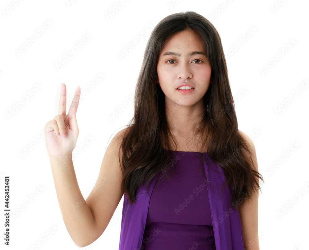 Serene ethnic female pointing up with index finger on white background in studio and looking at camera Serene ethnic female pointing up with index finger on white background in studio and looking at camera