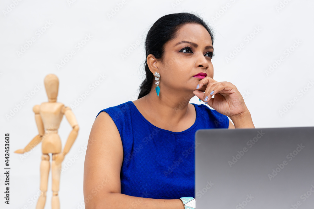 Pretty Indian woman at the table, Freelancer, distant work, work at home, online education, Office work at home, Lost in thought. Pretty Indian woman at the table, Freelancer, distant work, work at home, online education, Office work at home, Lost in thought.