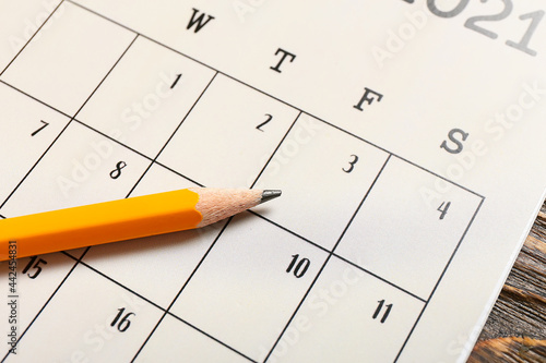 Flip paper calendar and pencil, closeup
