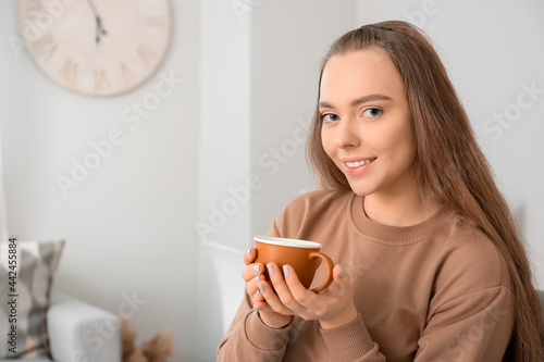 Beautiful woman with cup of...