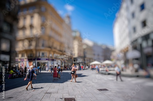 Crowd of anonymous people walking on busy city street © babaroga