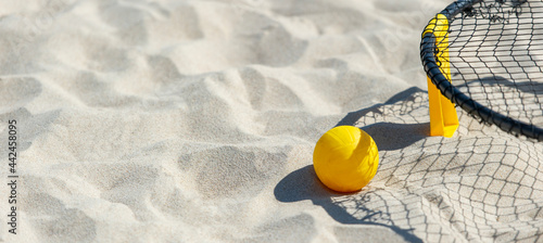 Valokuva Spike ball game with yellow ball on sand. Summer game concept