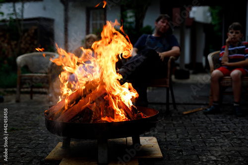 Bonfire with sparks flying around. Summer camp fire for adults and children. photo