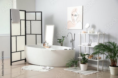 Interior of stylish bathroom with folding screen