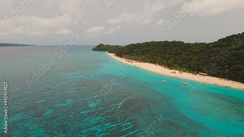Aerial view of beautiful tropical island with white sand beach, hotels and tourists, Boracay, Puka shell beach. Tropical lagoon with turquoise water and white sand. Beautiful sea, beach, resort