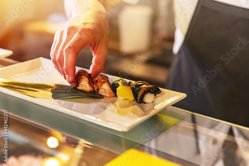 Chef serving traditional japanese sushi