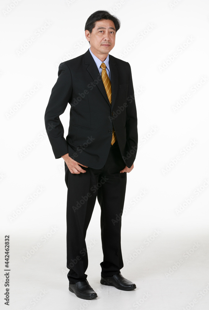 50s aged Asian senior executive businessman wearing formal suit with luxury necktie, standing in indoor office, looking at camera, smiling with satisfaction, confidence. 50s aged Asian senior executive businessman wearing formal suit with luxury necktie, standing in indoor office, looking at camera, smiling with satisfaction, confidence.