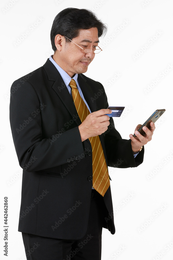 Senior man standing, checking payment his credit card through mobile phone. Seems his wife spent over budget on online shopping discount sale last moment. Senior man standing, checking payment his credit card through mobile phone. Seems his wife spent over budget on online shopping discount sale last moment.