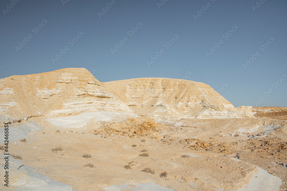 Beautiful lunar landscape. Wight and smooth hills in various shapes in a desert landscape. The whitish, rounded, winding, and smooth chalk rocks. Israel. High quality photo