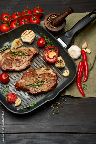 Grilled roated beef steaks on frying pan