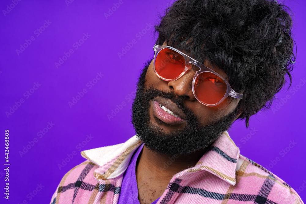 Fashion portrait of african american man in glasses against purple background Fashion portrait of african american man in glasses against purple background