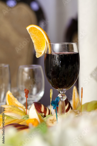 Wallpaper Mural Glass of red wine and a slice of orange fruit snacks on the banquet table Torontodigital.ca