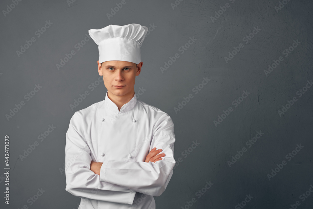 male chef professional in uniform working in a restaurant male chef professional in uniform working in a restaurant