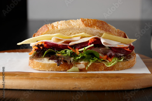 Healthy ham, cheese and salad sandwich on board photo