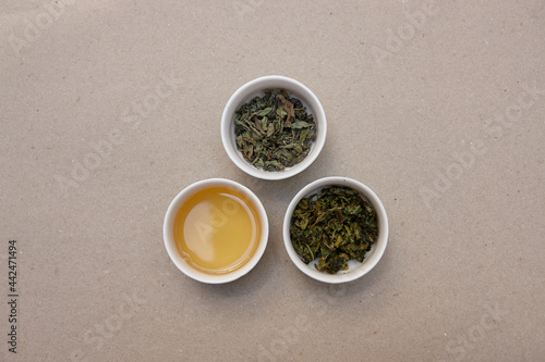 Tea leaves and drink on table photo