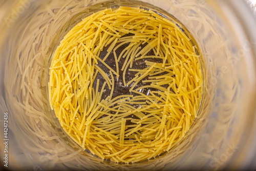 Billede på lærred Top view of an open jar with pasta at the bottom of the jar.