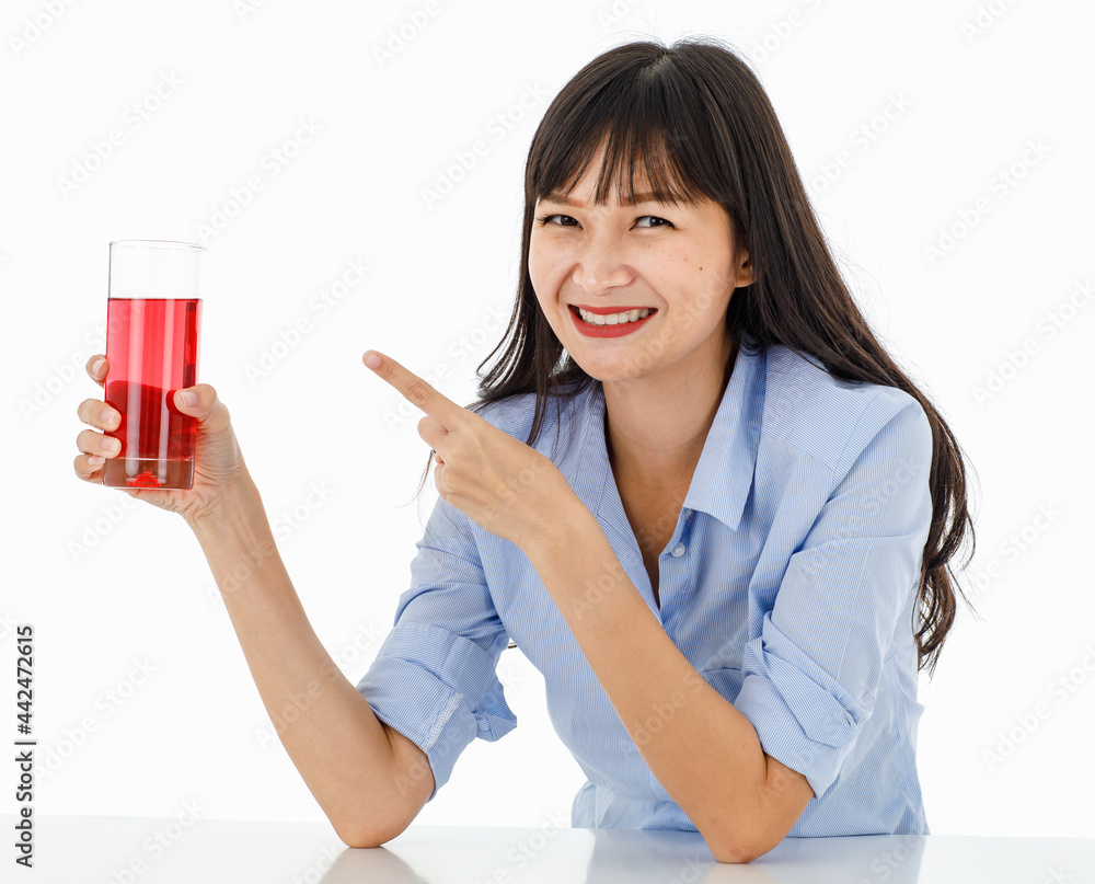 Friendly long-hair lady with charming smile and eyes in a blue shirt. Look at hand holding a juice glass. Portrait with white background. Feel fresh, fun, refreshing, healthy. Friendly long-hair lady with charming smile and eyes in a blue shirt. Look at hand holding a juice glass. Portrait with white background. Feel fresh, fun, refreshing, healthy.