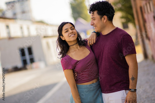 Couple standing on street. © liderina