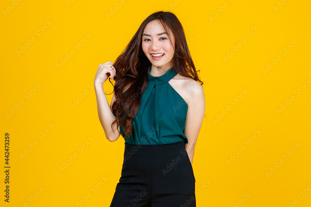 30s cute and charming curly hair Asian female brunette pose to camera with a joyful and positive gesture for advertising use purpose. Taken with studio flash isolated on yellow background 30s cute and charming curly hair Asian female brunette pose to camera with a joyful and positive gesture for advertising use purpose. Taken with studio flash isolated on yellow background
