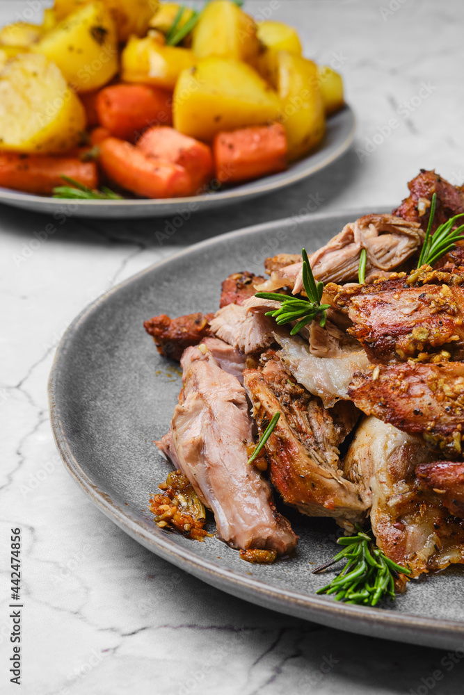 Closeup view of pulled lamb shoulder meat baked in oven with potato and carrot Closeup view of pulled lamb shoulder meat baked in oven with potato and carrot