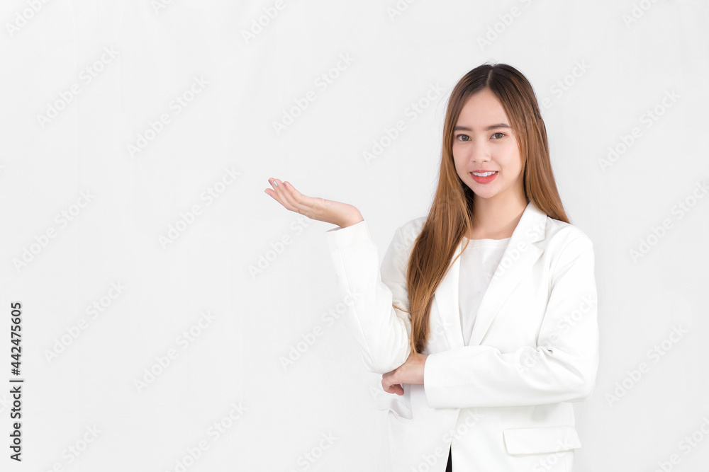 Asian business woman with bronze long hair wearing a white suit and pretty smiling is present product on white background. Asian business woman with bronze long hair wearing a white suit and pretty smiling is present product on white background.