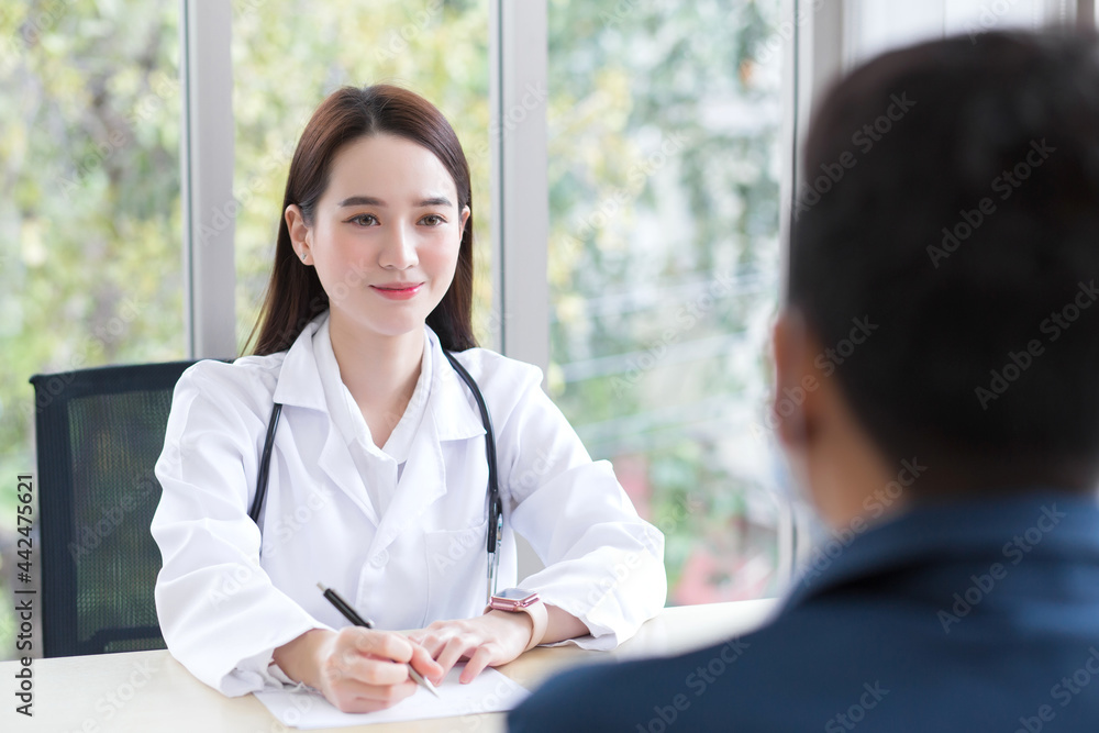 Asian professional woman doctor who wears medical coat talks with a man patient to consult and suggest healthcare information to him. Asian professional woman doctor who wears medical coat talks with a man patient to consult and suggest healthcare information to him.