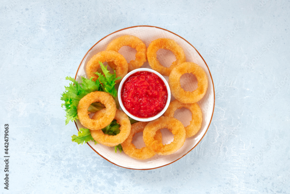 Calamari rings with green salad. Deep fried squid rings, overhead shot Calamari rings with green salad. Deep fried squid rings, overhead shot