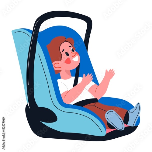 Baby boy sitting in children car seat with handle