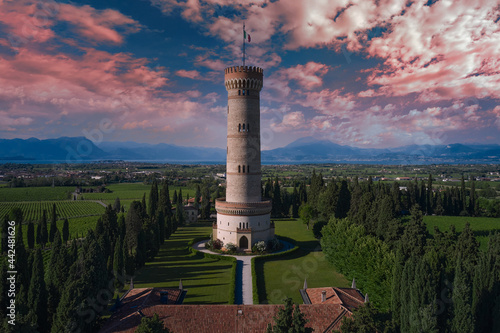 Aerial view of the Tower of San Martino della Battaglia at sunset. The famous Tower of San Martino della Battaglia, Lake Garda Italy. Italian tower on a background of pink clouds.