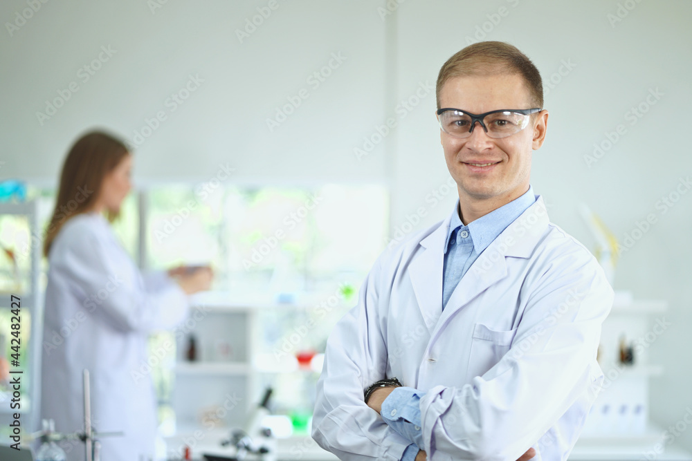 Smiling male scientist with Scientist team workers standing in the Laboratory, Covid-19. Smiling male scientist with Scientist team workers standing in the Laboratory, Covid-19.