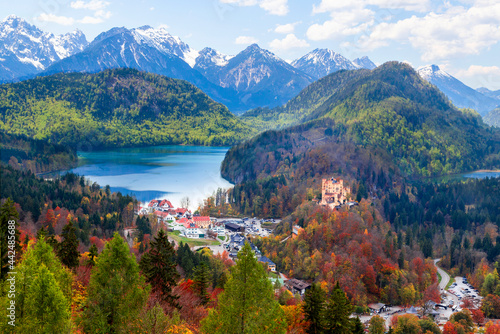Landscape of Hohenschwangau Castle, Bavaria, Germany. Beautiful panorama of mountain lakes. Scenery of Alpine nature in autumn. Aerial scenic view of village in Alps.