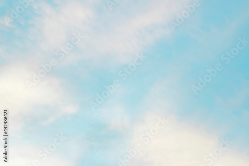 Blue sky and white clouds  abstract natural background on a bright sunny day. The concept of freedom  tourism  recreation  travel. Layout for design.