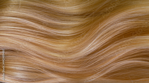 Macro shot of beautiful healthy long smooth flowing blonde hair.