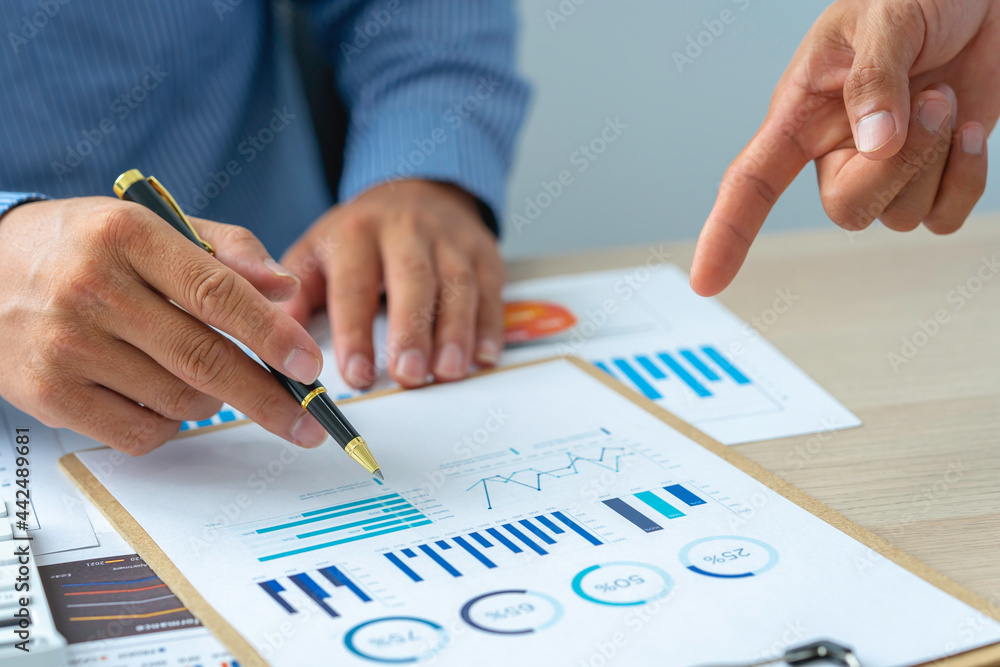 Close up account man hand using calculator for calculate and writing make a note with pen, ..financial reporting and business performance to check investment results Close up account man hand using calculator for calculate and writing make a note with pen, ..financial reporting and business performance to check investment results