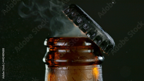 Freeze motion of opening beer bottle. Macro shot.