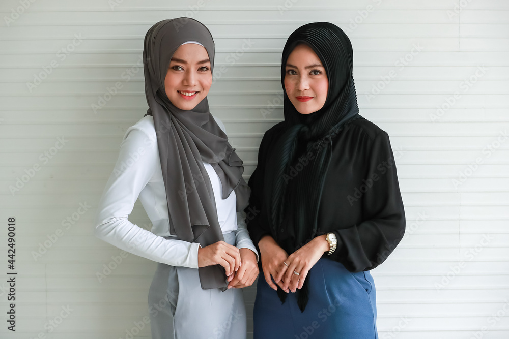 Smiling Muslim women in office outfit and hijabs