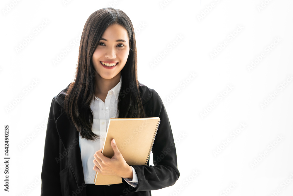 Beautiful Asian female secretary in black suit standing with smile face and self-confident in office and holding document file with copyspace Beautiful Asian female secretary in black suit standing with smile face and self-confident in office and holding document file with copyspace