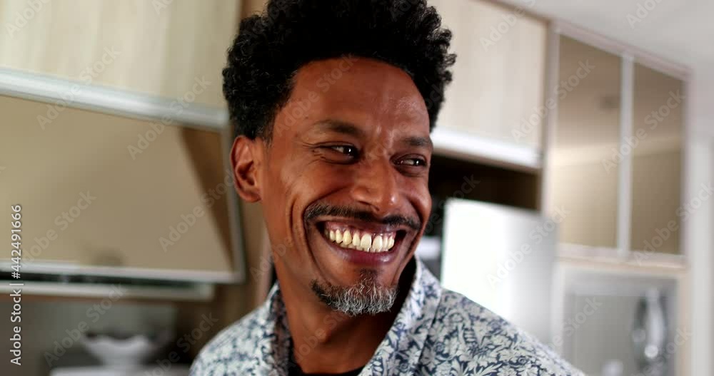 Happy African man grimacing doing funny faces and smiling Happy African man grimacing doing funny faces and smiling