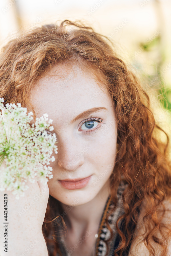 Naklejka premium Red hair woman in the summer locations